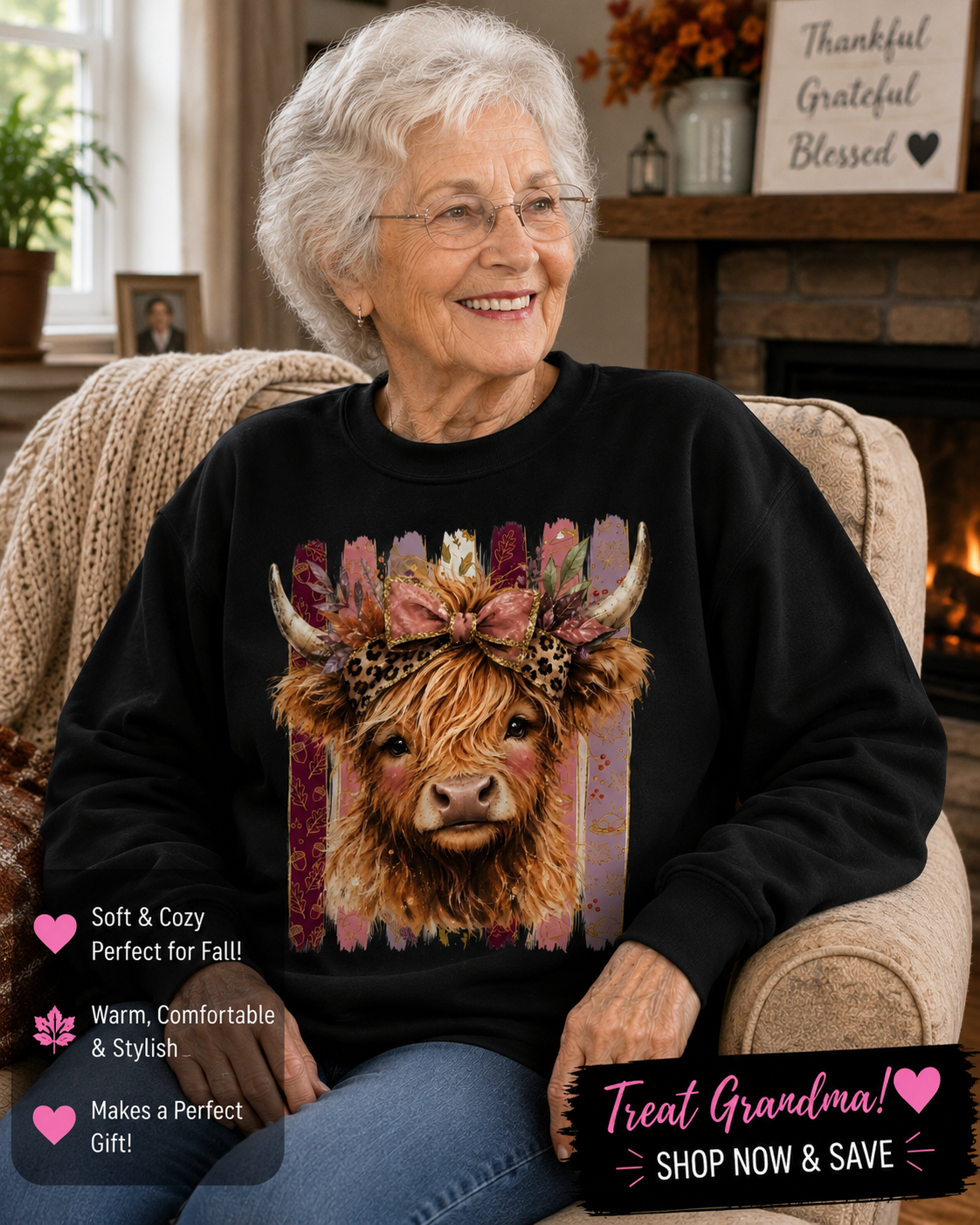 An elderly woman with white hair and glasses is sitting in a cozy living room, wearing a black crewneck sweatshirt with a colorful graphic of a Highland cow wearing a floral crown. The image includes promotional text overlays.