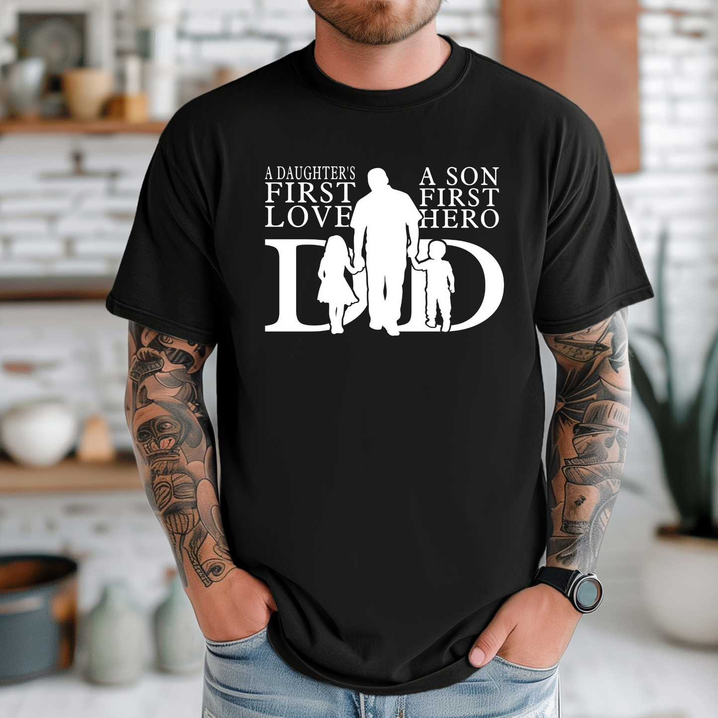 Person wearing a black t-shirt with a family graphic and text in a kitchen setting