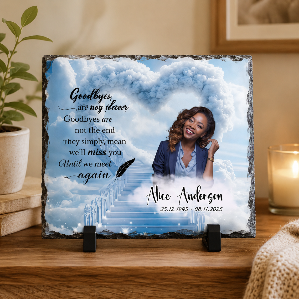Personalized memorial slate plaque on a wooden stand, featuring a photo of a smiling woman, blue clouds, a staircase, and the text 'Goodbyes are not forever' and 'Alice Anderson 25.12.