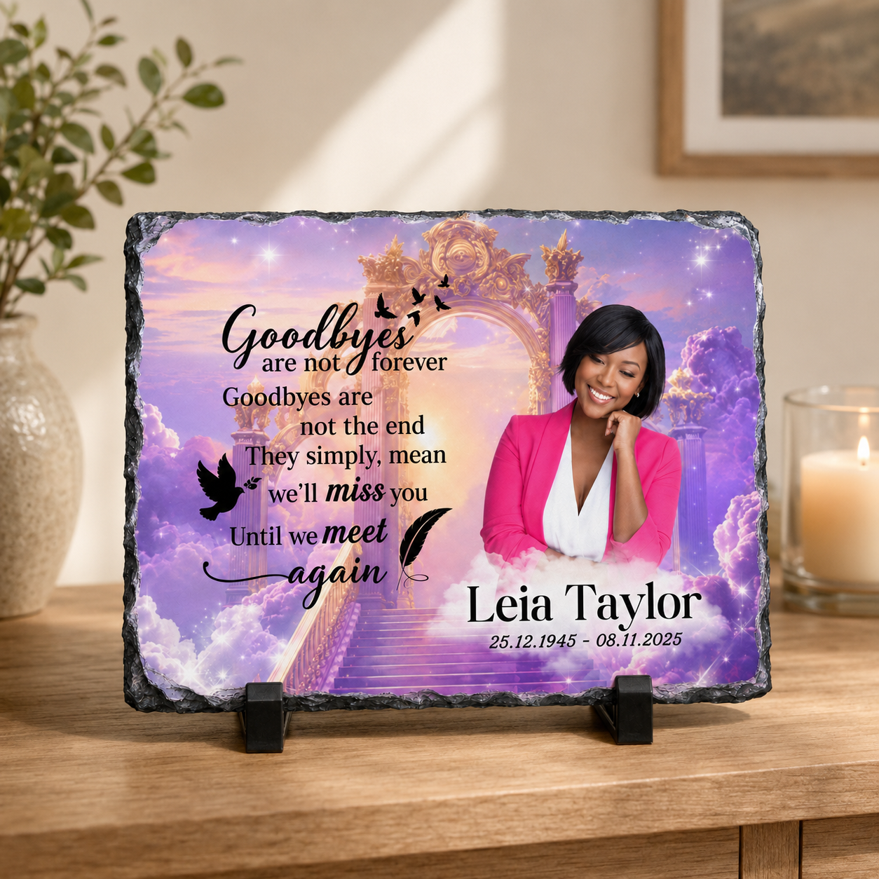 Personalized memorial slate plaque on a wooden stand, featuring a purple and blue sky background with clouds, a golden archway, a portrait of a woman in a pink blazer, and the text 'Goodbyes are not forever' and 'Leia Taylor 25.12.