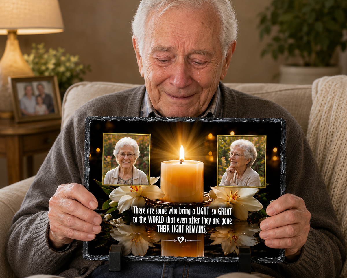 An elderly man sits on a couch holding a memorial-style photo display or tablet with two photos of himself, a large candle graphic, flowers, and a quote. A real indoor living-room environment is visible in the background, so this is Lifestyle rather than Product/Packaging.